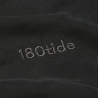 Close-up of the tonal 180tide chest embroidery on the Onyx Logo Hoodie