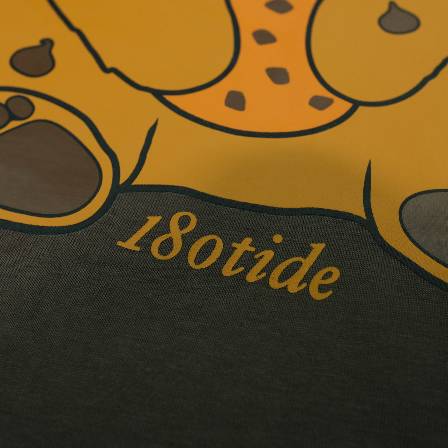 Detail of the Chip the Cookie Bear back print with 180tide script on the Espresso tee