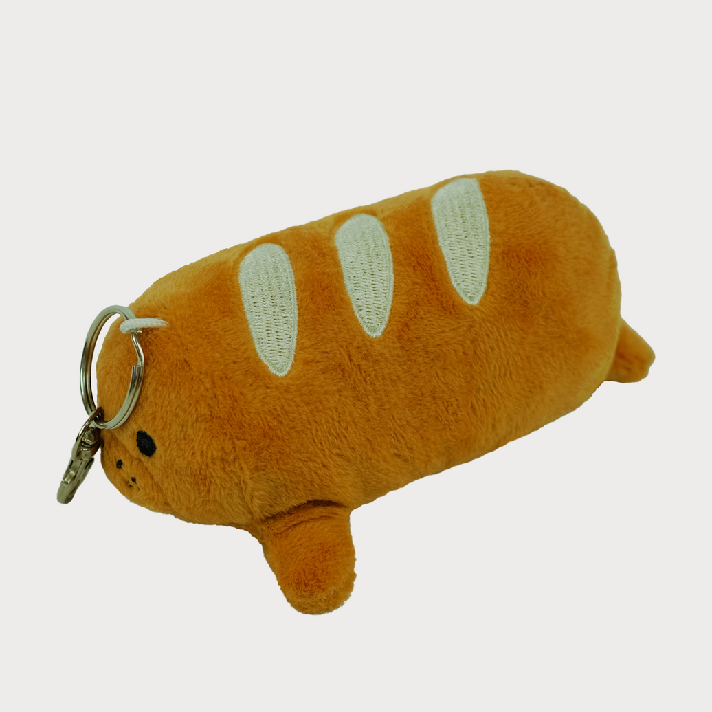 Louis the Baguette Manatee Plush Keychain, lying side view