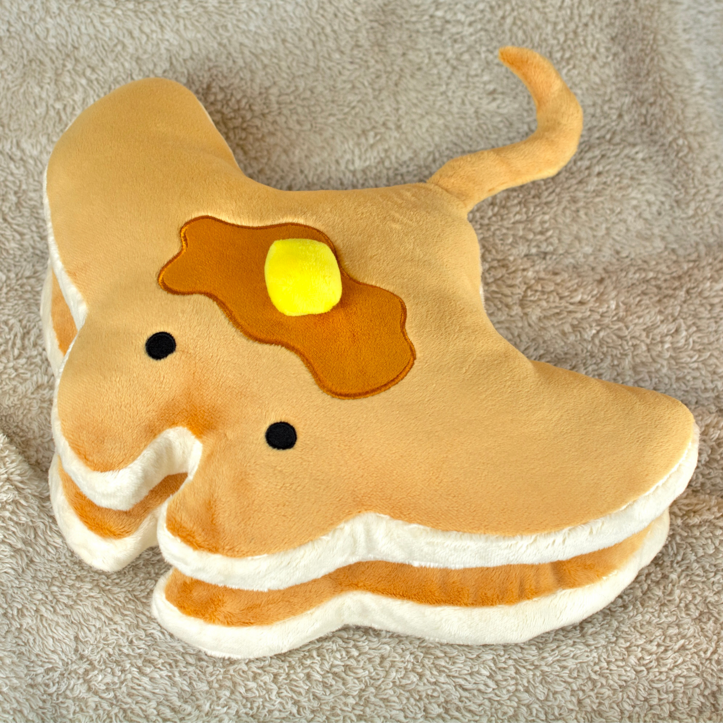 Stacks the Pancake Manta Ray Plush, styled in a home setting