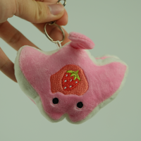 Strawberry Stacks the Pancake Manta Ray Plush Keychain, held in hand